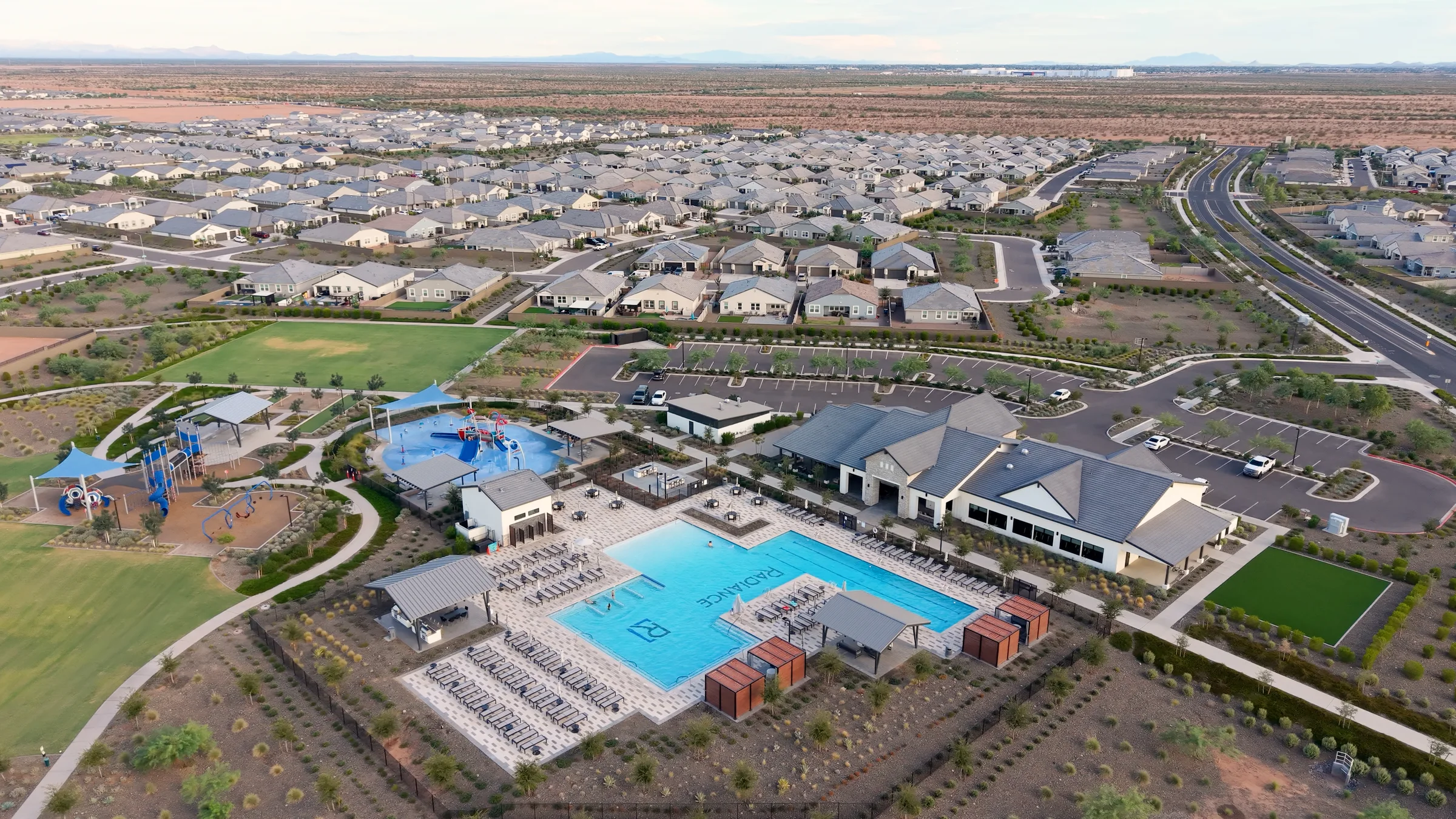 Aerial view of Radiance’s pool, clubhouse, splash pad and playground surrounded by landscaped paths and homes.