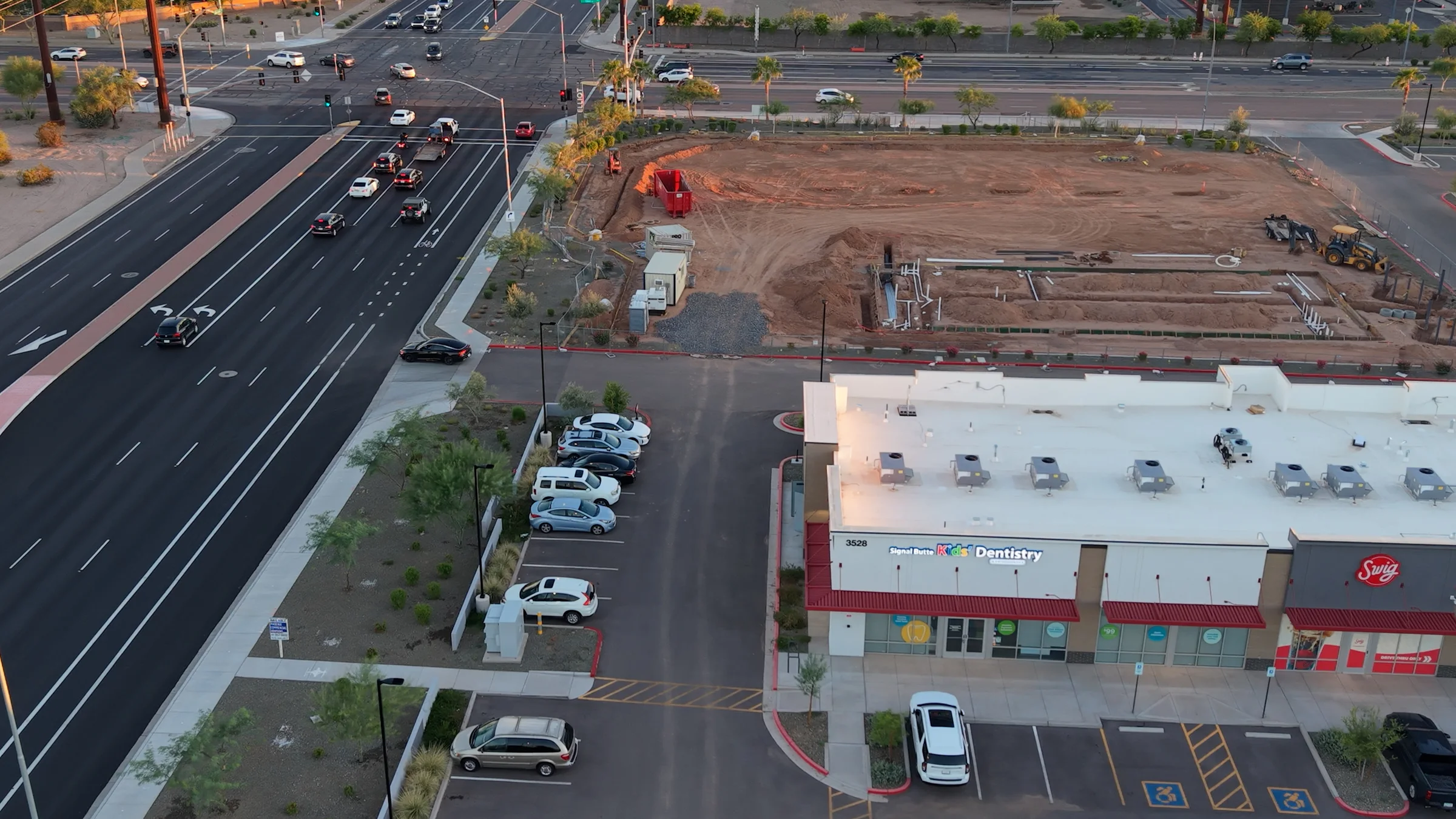 The fenced corner construction site beside the building marked 3528, home to Signal Butte Kids’ Dentistry and Swig.