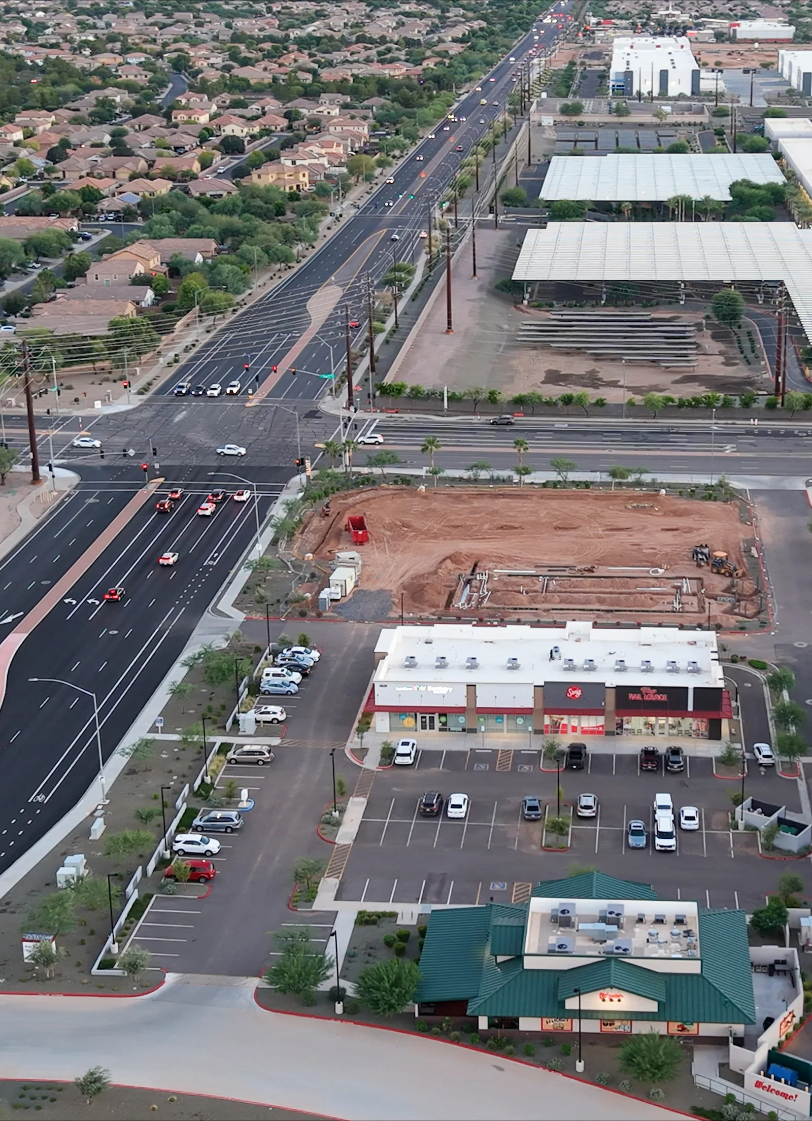 Aerial view with Oregano’s in the foreground, neighboring shops and the Signal Butte Road and Elliot Road intersection beyond.