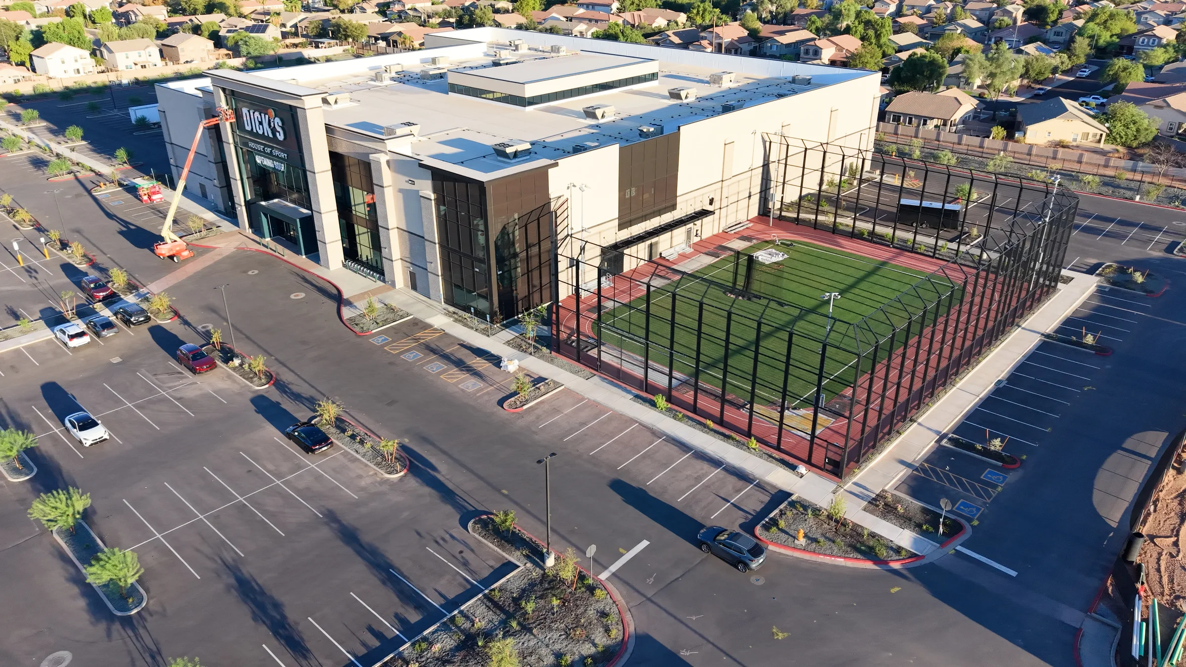 Wide aerial view of Gilbert’s new DICK’S House of Sport, outdoor sports field, parking lot and surrounding homes.
