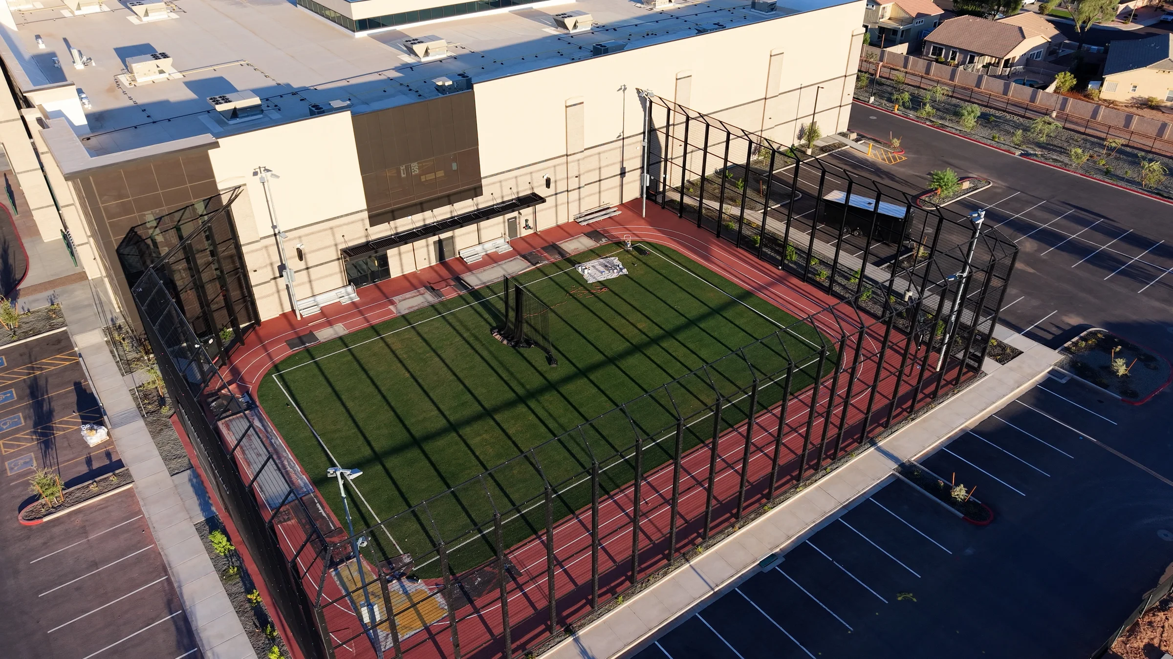 Aerial view of the fenced outdoor turf field and running track beside DICK’S House of Sport in Gilbert.