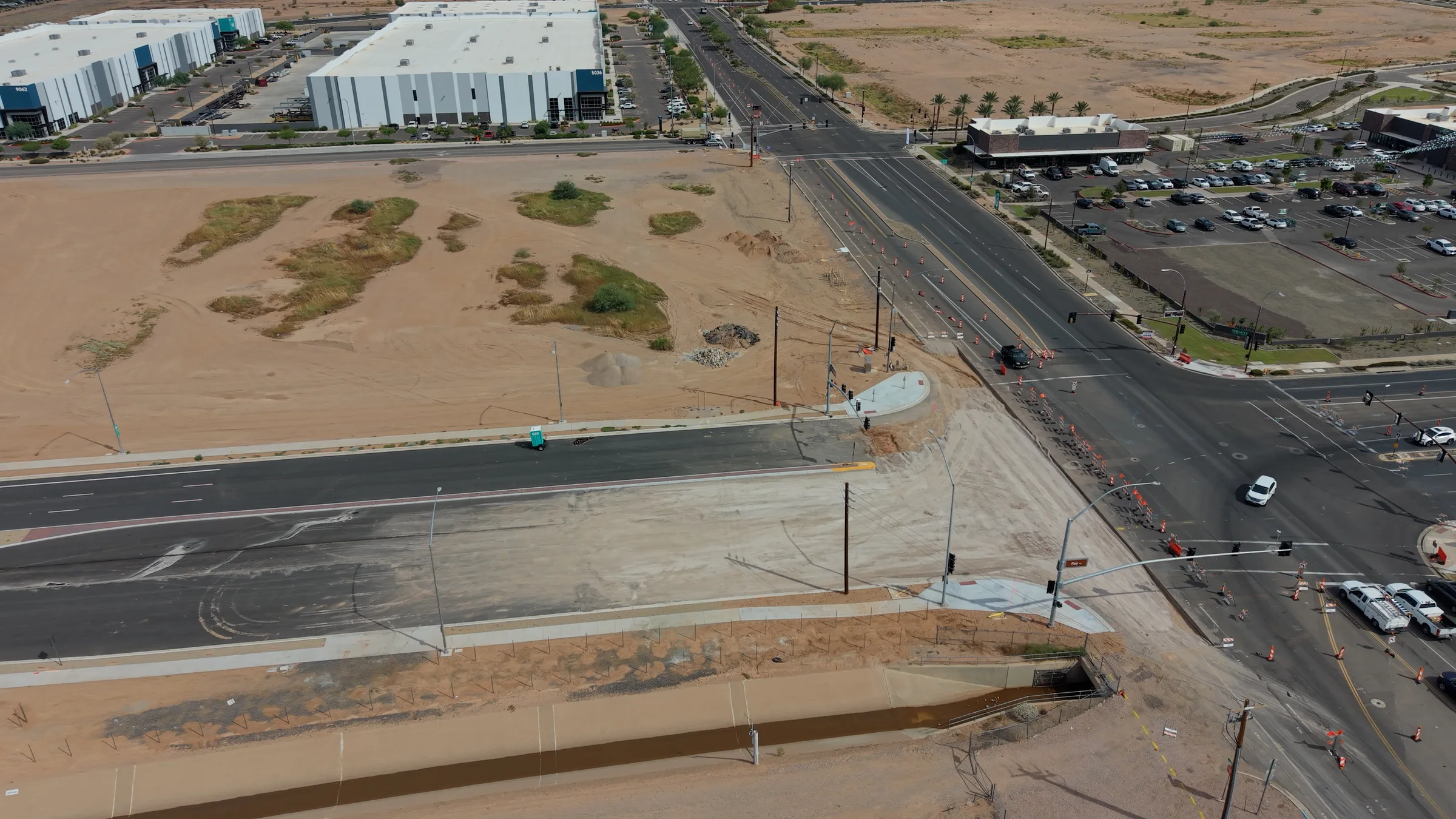 Wide September 21 aerial view of the Ray Road connection at Ellsworth, showing divided pavement, an unfinished approach and the drainage channel.