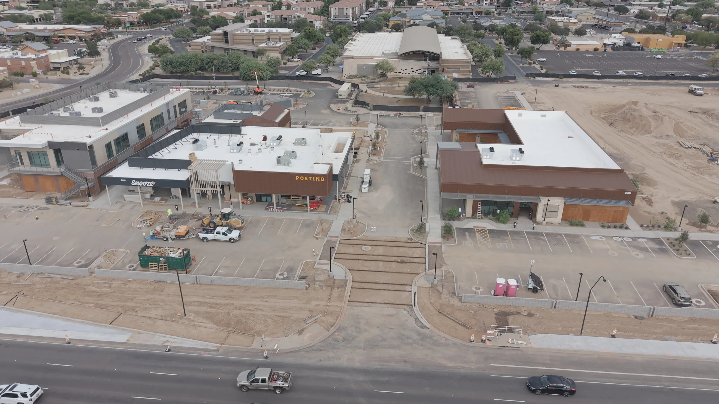 Aerial view of The Switchyard’s storefronts, parking areas and construction site.