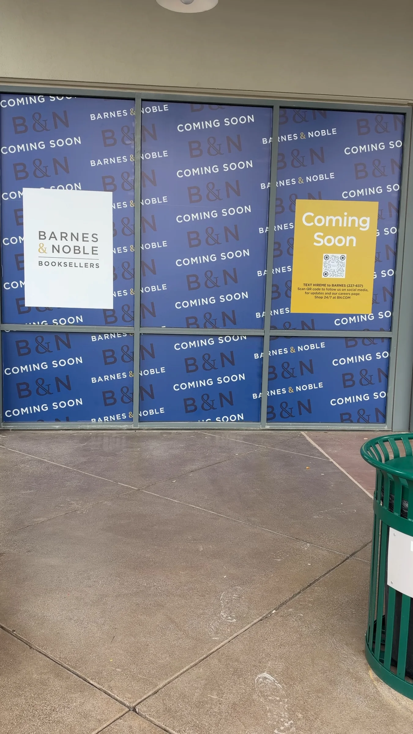 Barnes & Noble Booksellers and yellow Coming Soon posters on the blue-papered windows at Queen Creek Marketplace.
